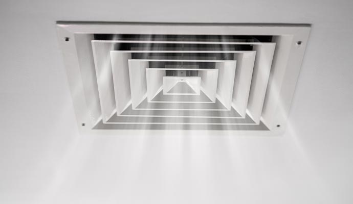 Clean ceiling air duct vent with visible airflow