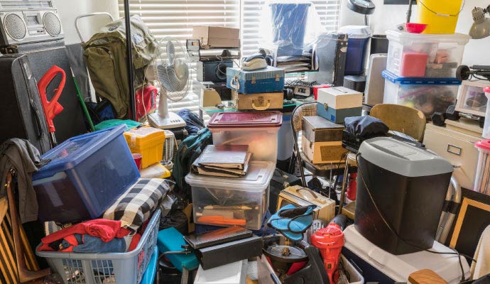 A room filled from floor to ceiling with a severe accumulation of household items