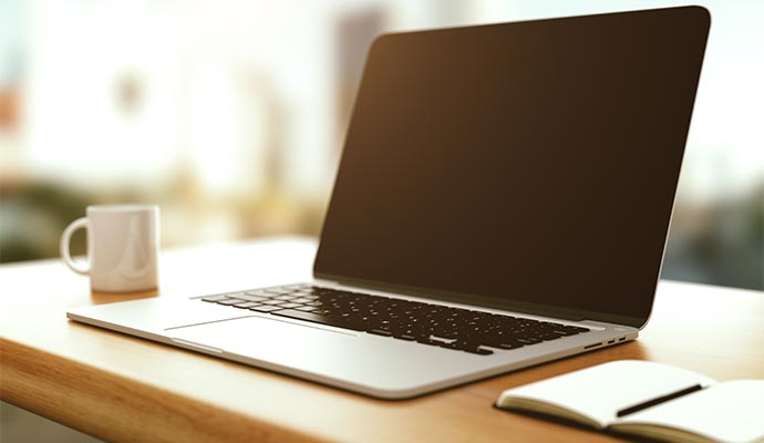 Blank screen laptop on a wooden desk