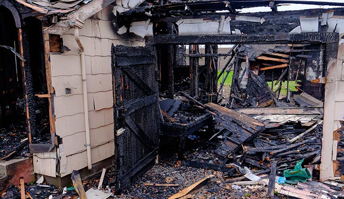 Charred residential structure after fire damage