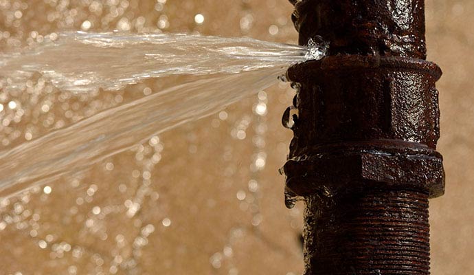 Water leaking out from a broken water pipe