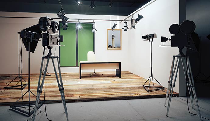 Studio cameras and lights facing desk