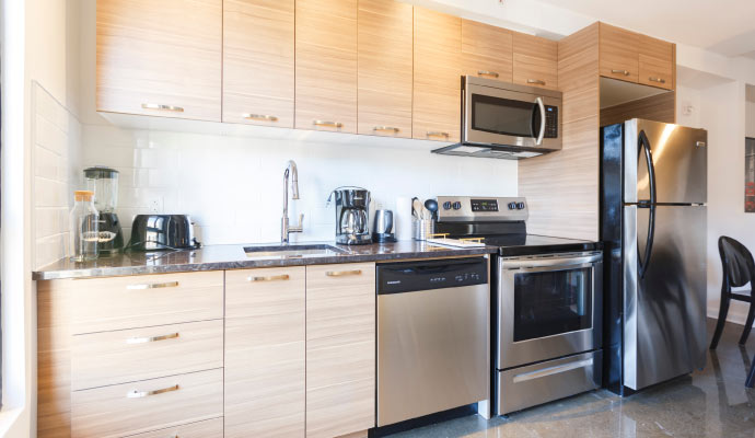 A modern kitchen with light wood cabinets
