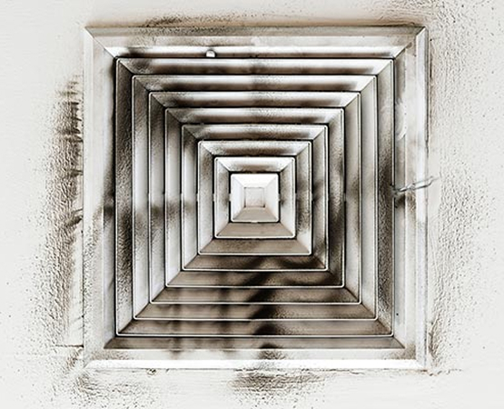 Air duct showing visible layers of dust buildup inside, indicating need for cleaning