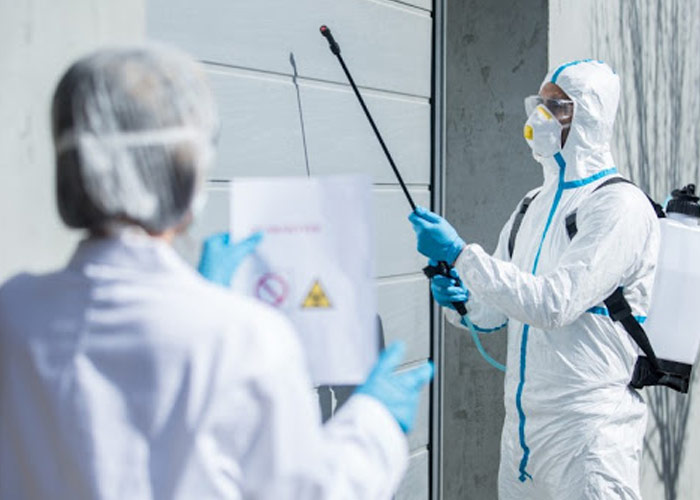 two individuals performing disinfecting service