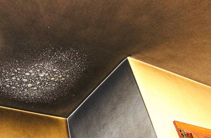 a ceiling stained by smoke