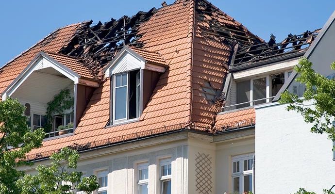 Exterior of a house showing severe structural damage from fire