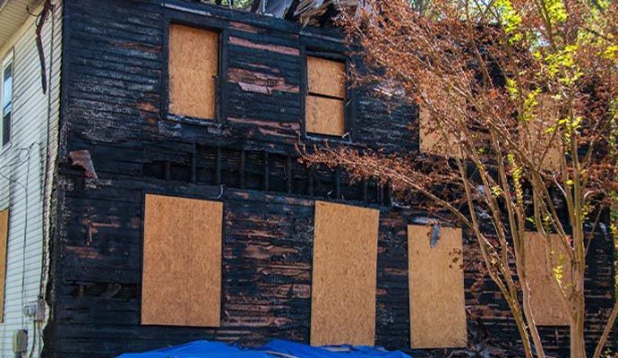 Fire damaged boarded-up house