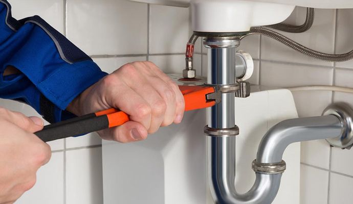 Professional worker fixing plumbing issue