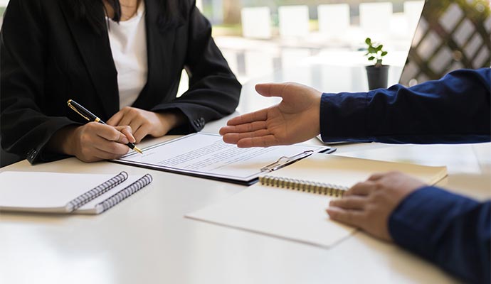 Client signing an insurance claim document