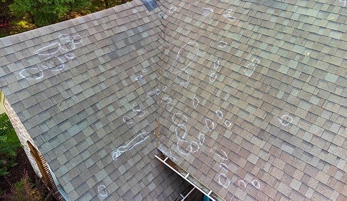 Hail-damaged roof highlighted with white circles