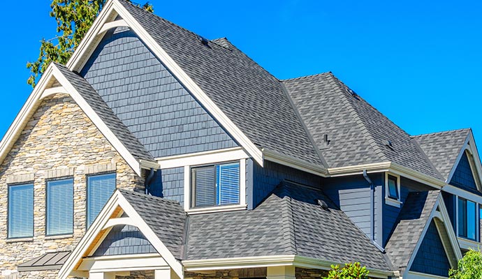 Modern house exterior with gray shingle roof Close-up view of a modern house exterior featuring a gray shingle roof