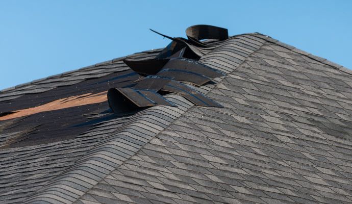 Residential roof with visible shingle damage