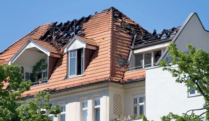 Structural fire damage and burned roof on a residential house