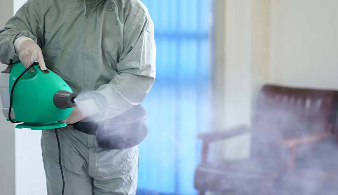 Technician fogging for smoke odor removal