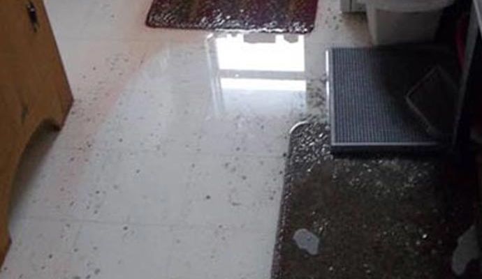 Wet tiled floor inside a home due to plumbing overflow
