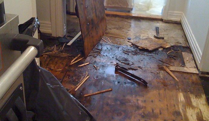 Water damaged wooden floor inside home Water damaged wooden floor inside home