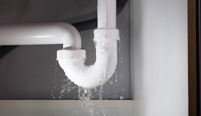 Water leaking from damaged pipe due to plumbing leak