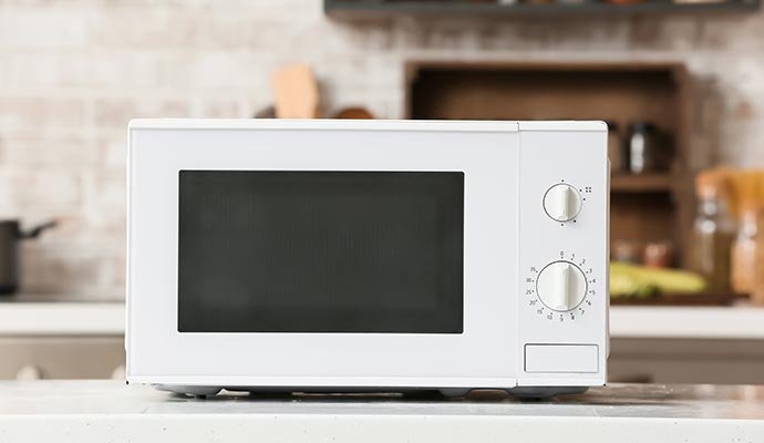 White microwave oven on a kitchen table