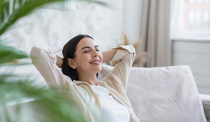 Woman relaxing in a fresh sanitized living room